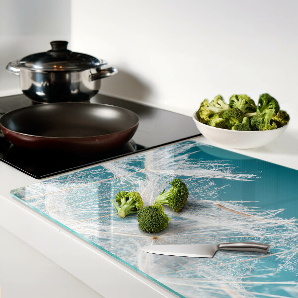 Chopping board glass Dandelions on a blue background
