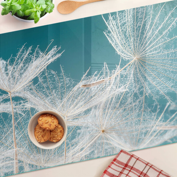 Chopping board glass Dandelions on a blue background