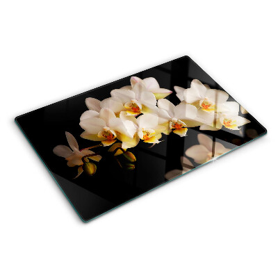 Chopping board glass Orchids on a black background