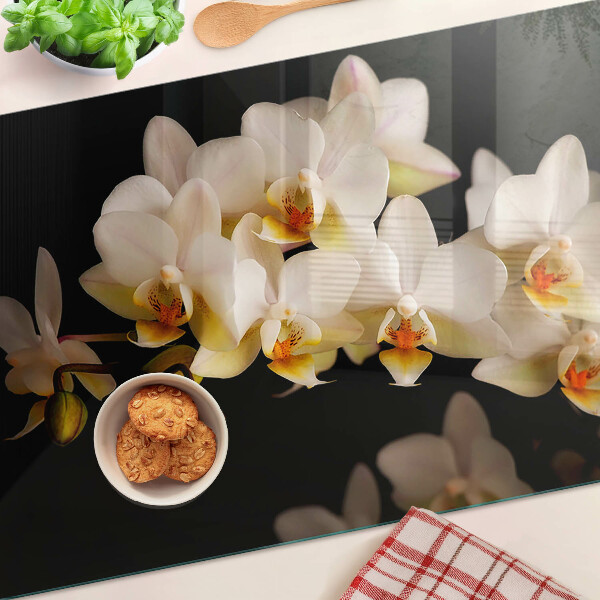 Chopping board glass Orchids on a black background