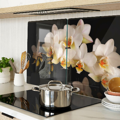 Chopping board glass Orchids on a black background