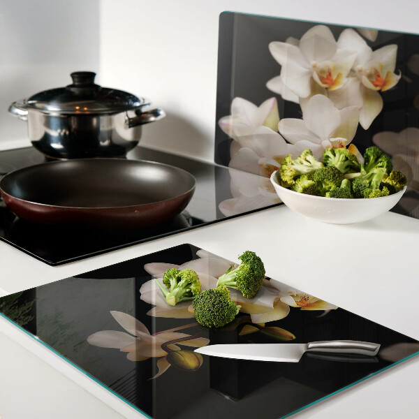 Chopping board glass Orchids on a black background