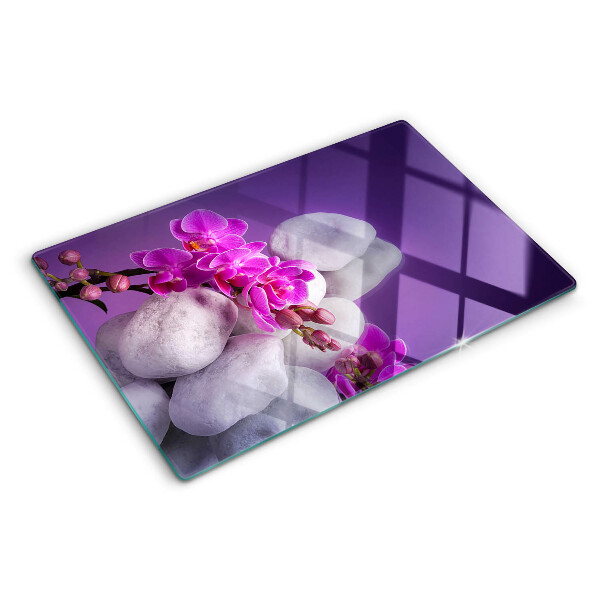 Cutting board Orchid flowers on a background of stones