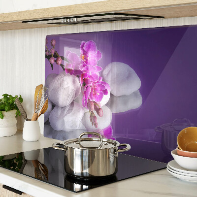 Cutting board Orchid flowers on a background of stones
