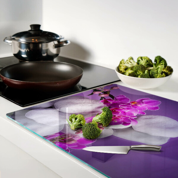 Cutting board Orchid flowers on a background of stones