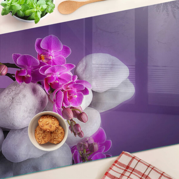 Cutting board Orchid flowers on a background of stones