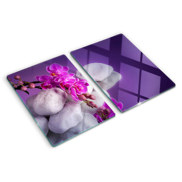 Cutting board Orchid flowers on a background of stones