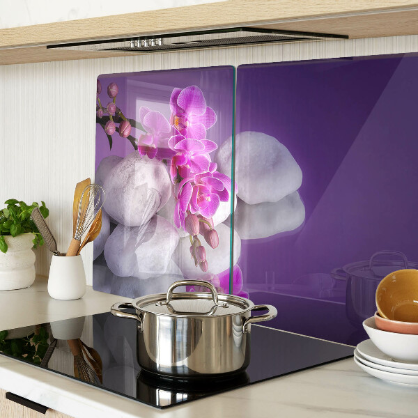 Cutting board Orchid flowers on a background of stones