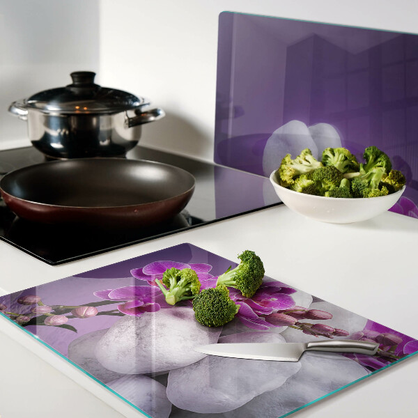 Cutting board Orchid flowers on a background of stones