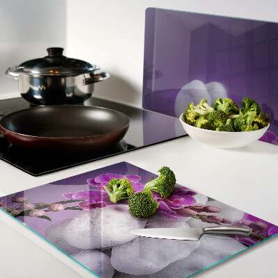 Cutting board Orchid flowers on a background of stones