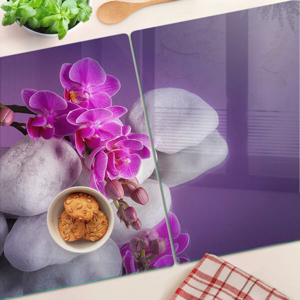Cutting board Orchid flowers on a background of stones