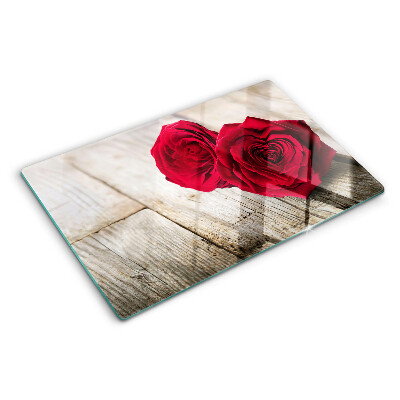 Glass chopping board Red roses on a wooden background