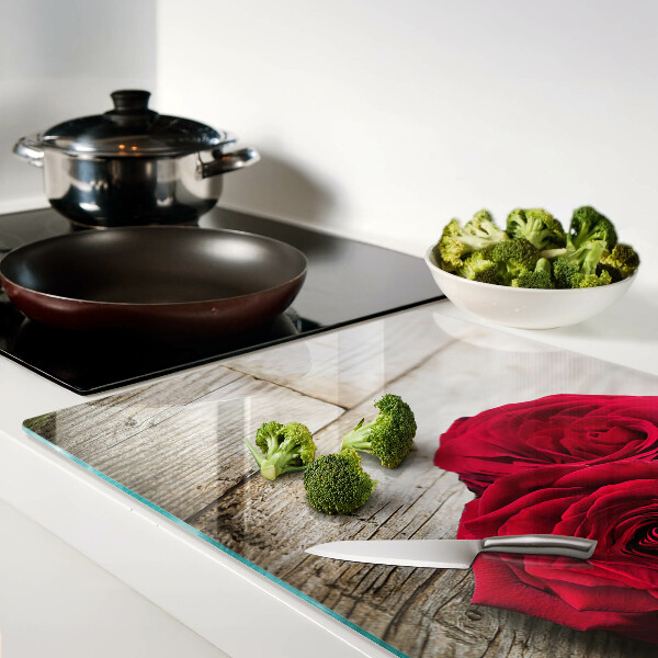 Glass chopping board Red roses on a wooden background