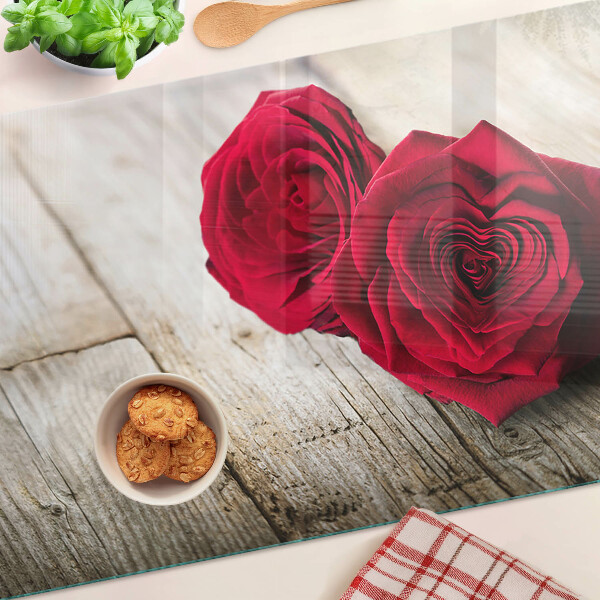 Glass chopping board Red roses on a wooden background