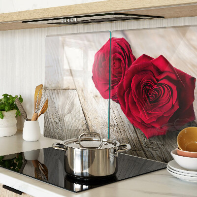 Glass chopping board Red roses on a wooden background