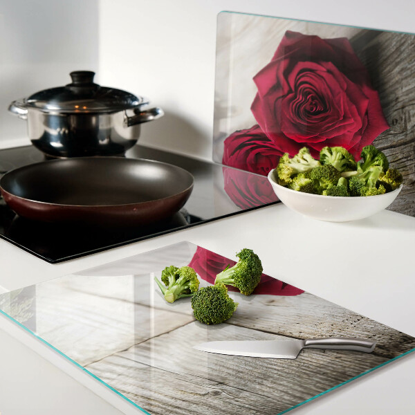 Glass chopping board Red roses on a wooden background