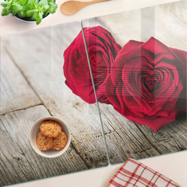 Glass chopping board Red roses on a wooden background