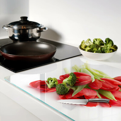 Glass kitchen board Red tulips on a white background