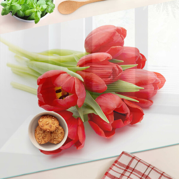 Glass kitchen board Red tulips on a white background