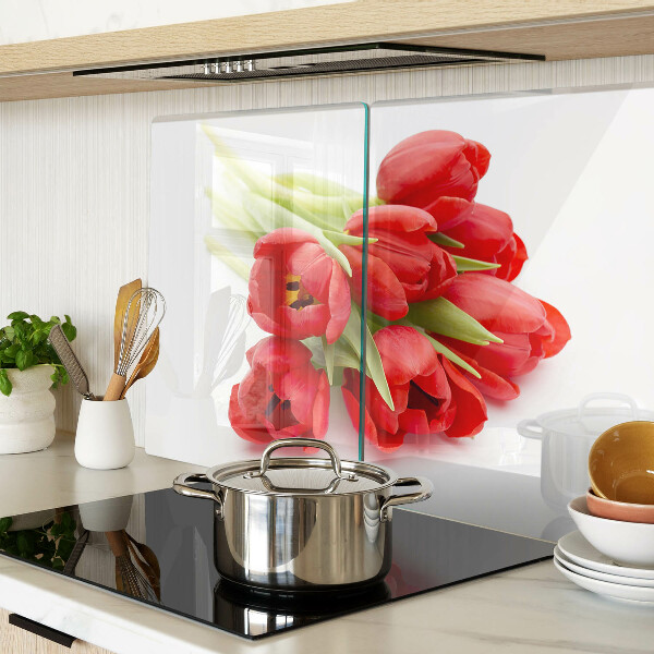 Glass kitchen board Red tulips on a white background