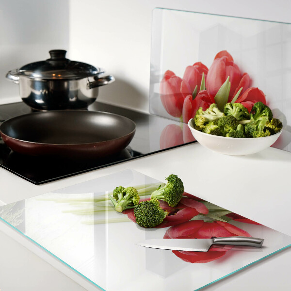 Glass kitchen board Red tulips on a white background
