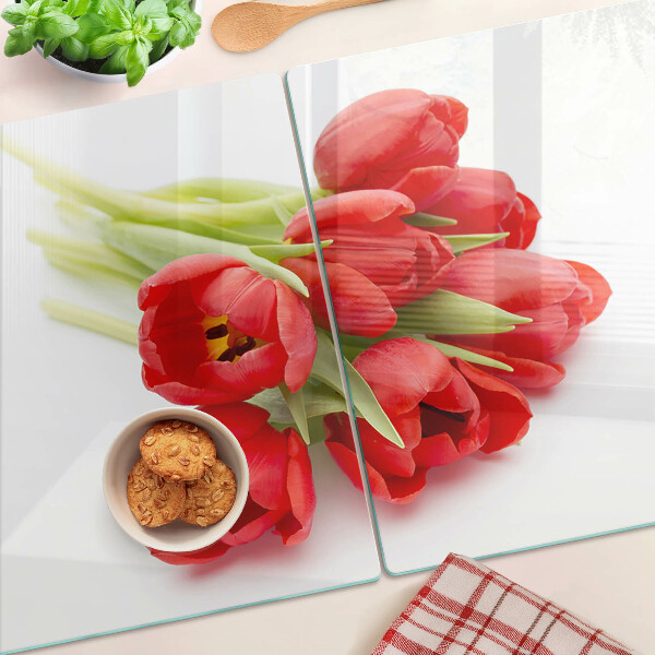 Glass kitchen board Red tulips on a white background