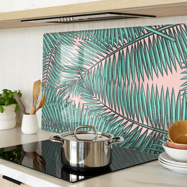 Glass cutting board Palm leaves on a pink background