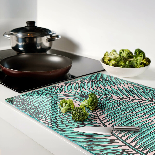 Glass cutting board Palm leaves on a pink background
