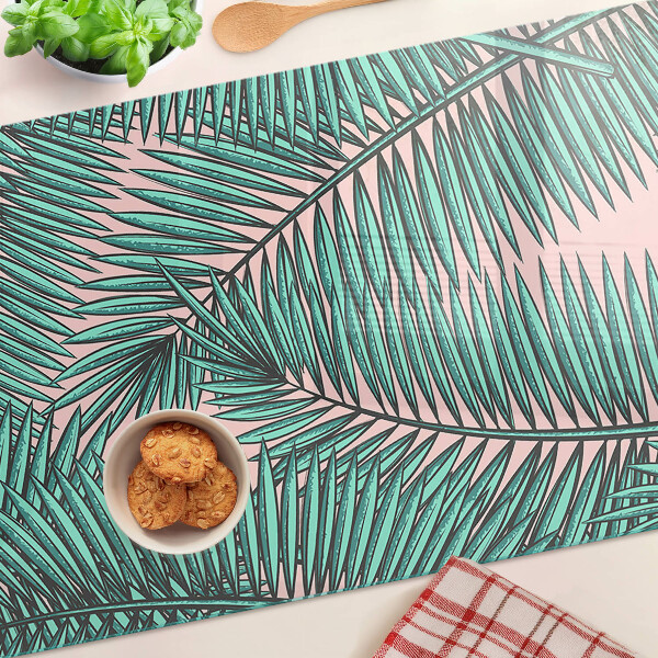 Glass cutting board Palm leaves on a pink background