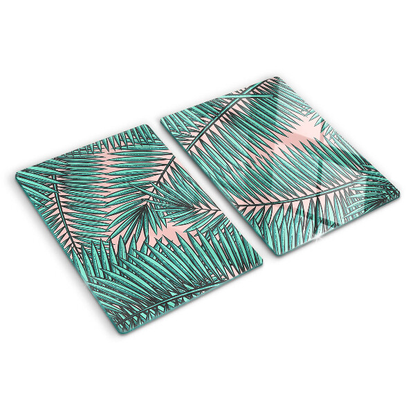Glass cutting board Palm leaves on a pink background