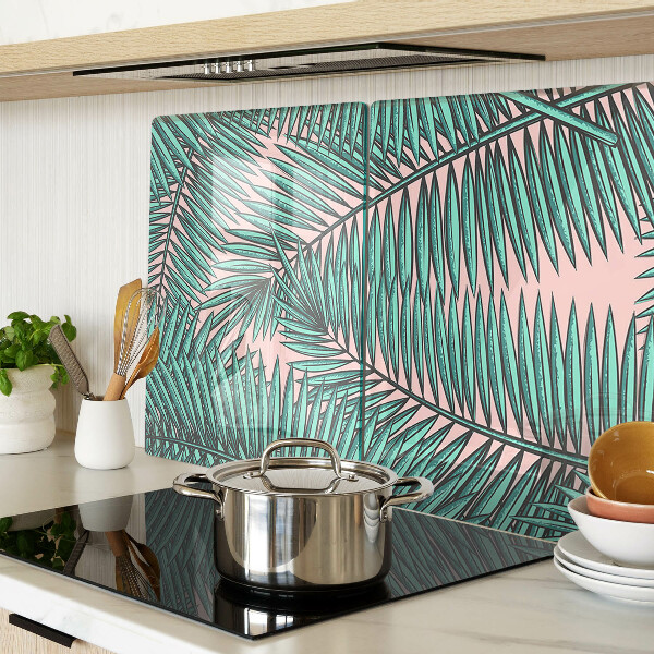 Glass cutting board Palm leaves on a pink background