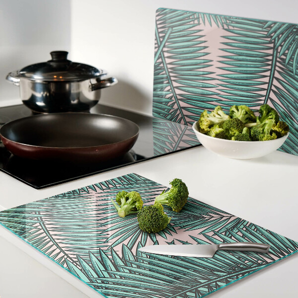 Glass cutting board Palm leaves on a pink background