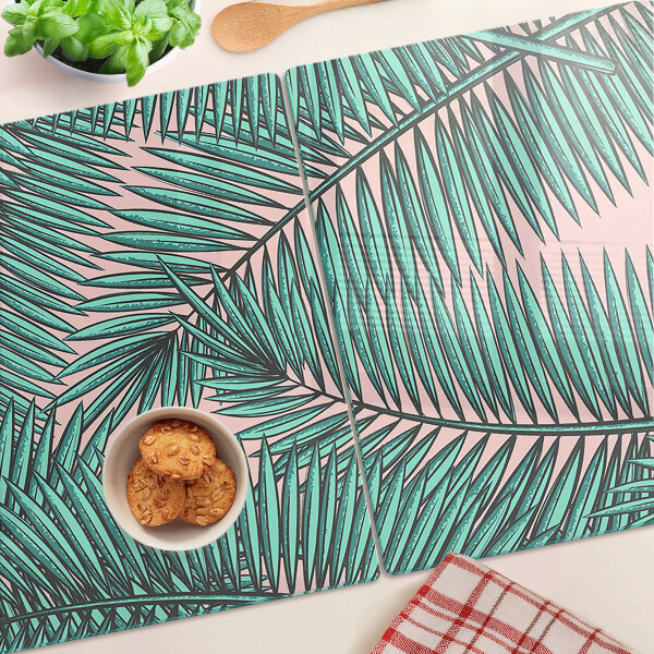 Glass cutting board Palm leaves on a pink background
