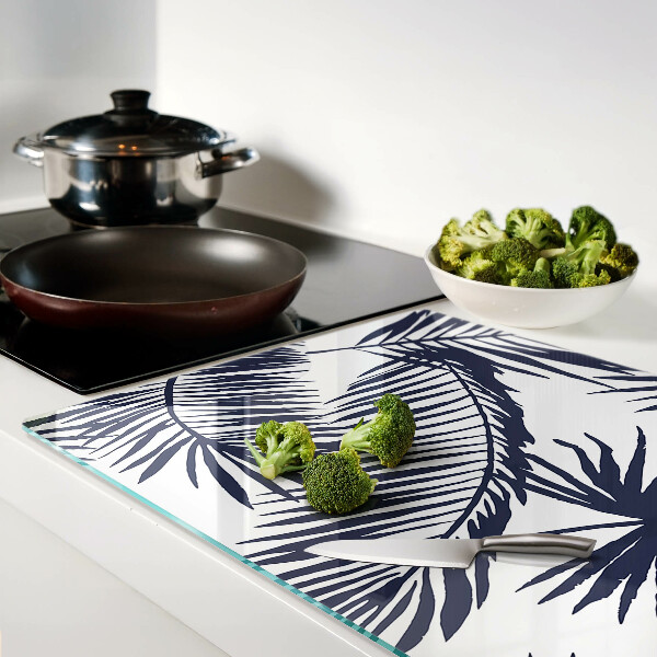 Chopping board glass Palm leaves on a white background