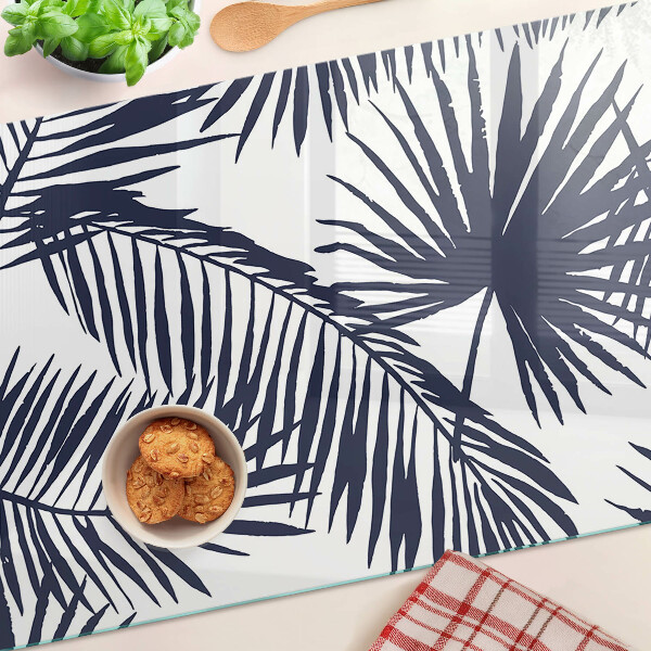 Chopping board glass Palm leaves on a white background