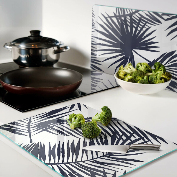 Chopping board glass Palm leaves on a white background