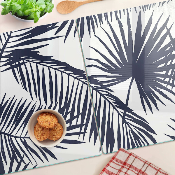 Chopping board glass Palm leaves on a white background