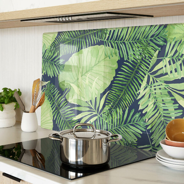Chopping board glass Tropical leaves on a dark background