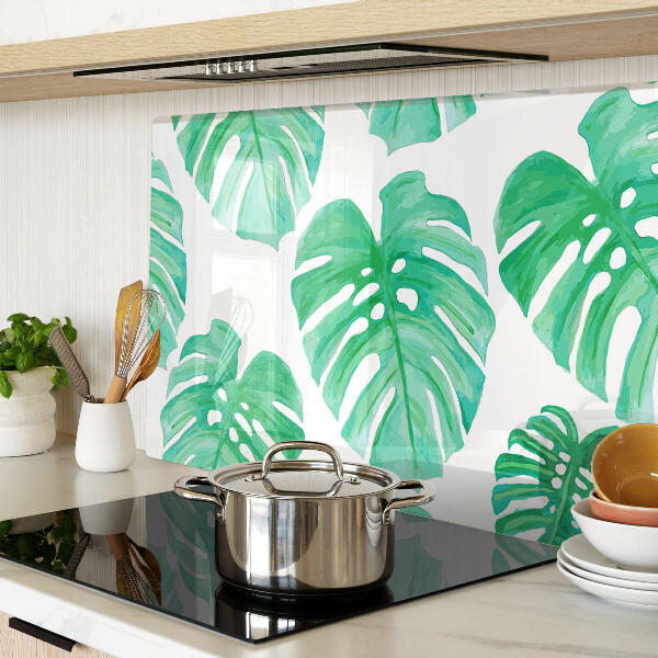 Glass cutting board Monstera leaves on a white background