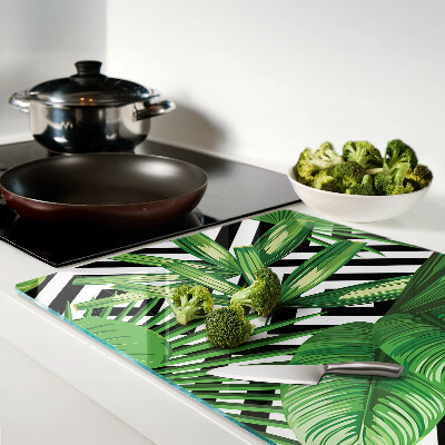 Glass kitchen board Tropical leaves on stripes