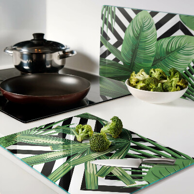 Glass kitchen board Tropical leaves on stripes
