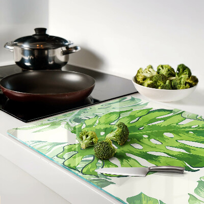 Glass kitchen board Monstera leaves on a light background