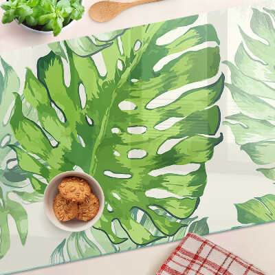 Glass kitchen board Monstera leaves on a light background
