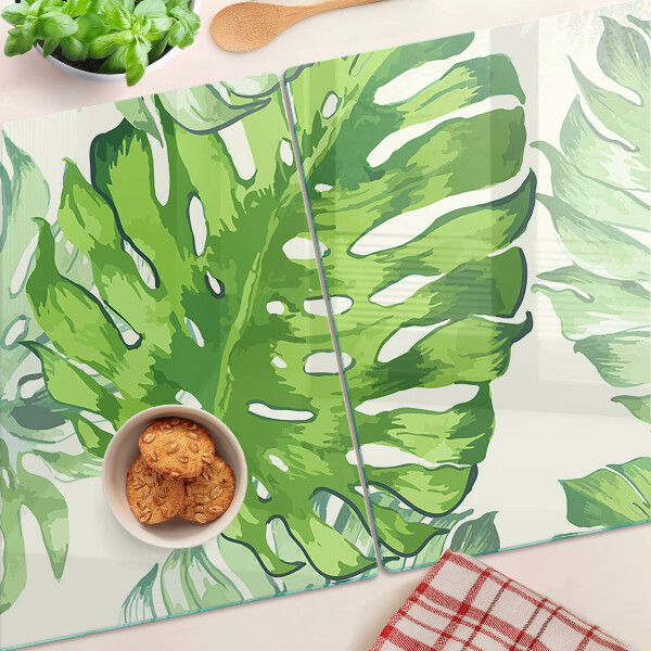 Glass kitchen board Monstera leaves on a light background