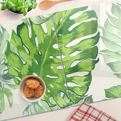 Glass kitchen board Monstera leaves on a light background