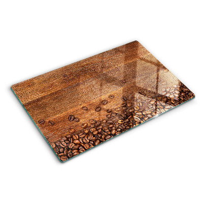Chopping board glass Coffee beans on a wooden background
