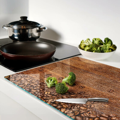 Chopping board glass Coffee beans on a wooden background