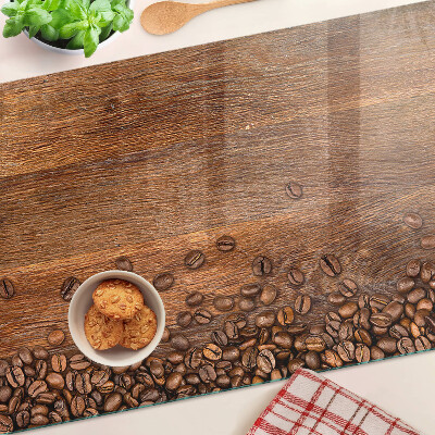 Chopping board glass Coffee beans on a wooden background