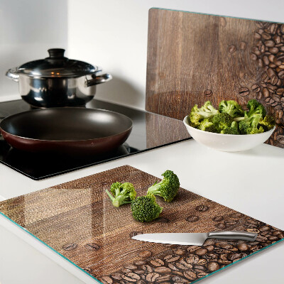 Chopping board glass Coffee beans on a wooden background