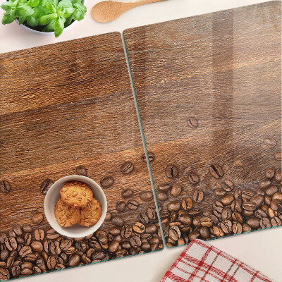 Chopping board glass Coffee beans on a wooden background